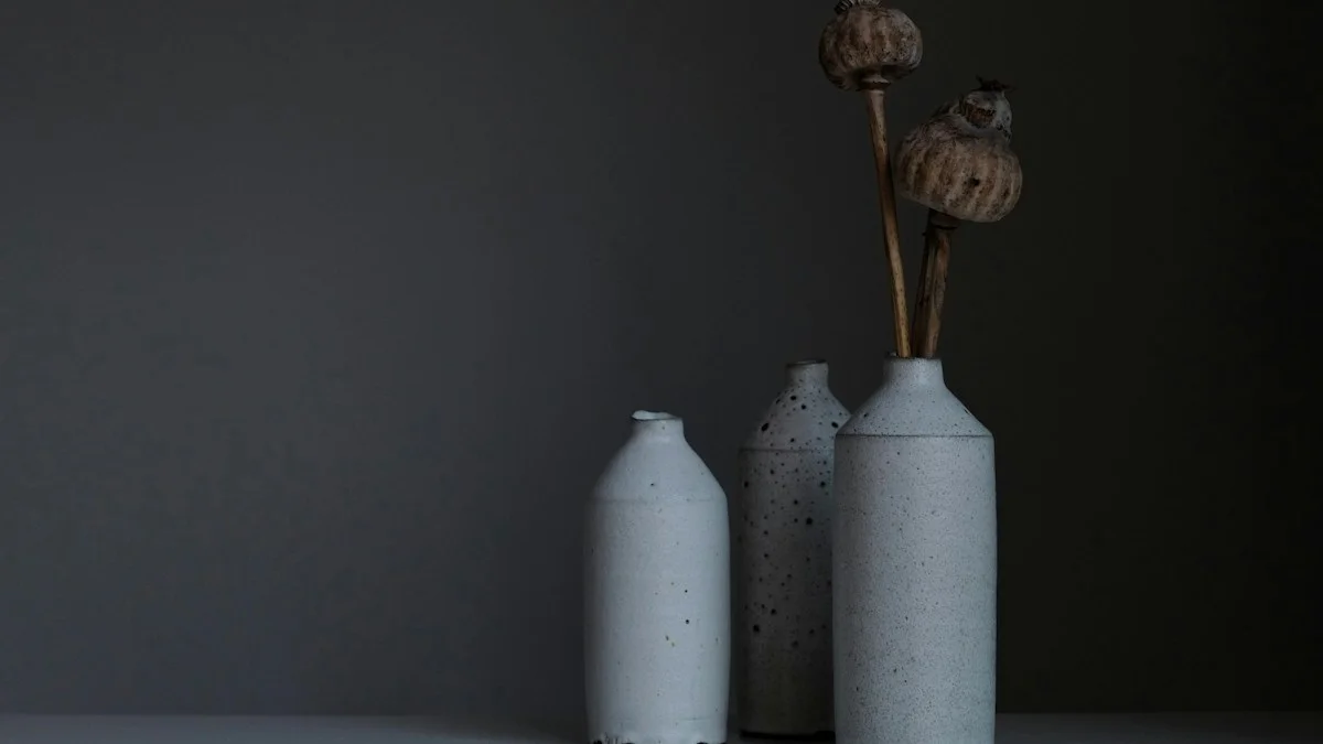 Ceramic artist working at pottery wheel in bright studio